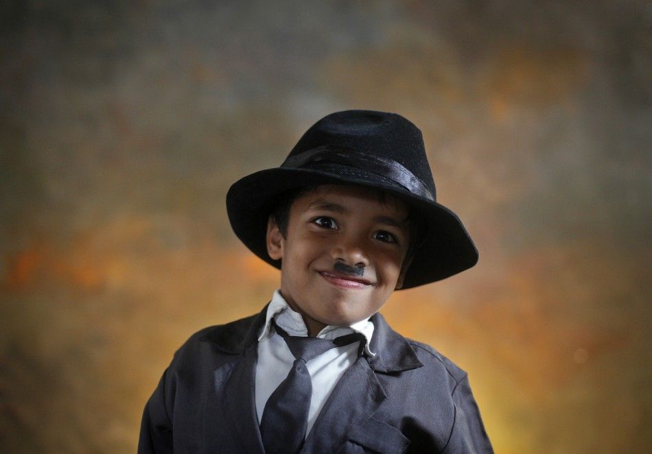 Yash, 7, a member of Charlie Circle, dresses up as Charlie Chaplin while posing inside a studio during Chaplins birthday celebrations in Adipur in the western Indian state of Gujarat
