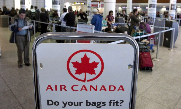 Air Canada travellers wait at the check-in area as baggage handlers at Pierre Elliott Trudeau airport walked off the job in Montreal