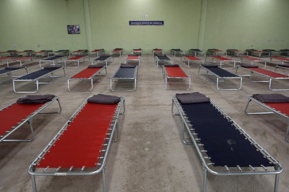 Folding beds are prepared at a permanent shelter in San Nicolas de los Ranchos