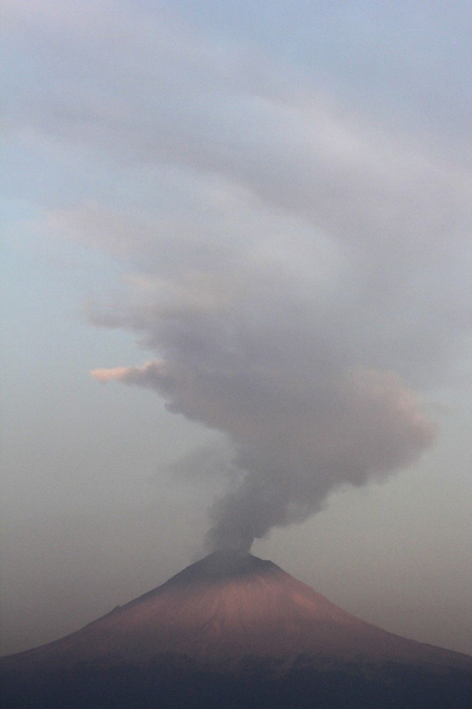 A plume of steam and ash is seen rising from the Popocatepetl volcano in San Nicolas de los Ranchos