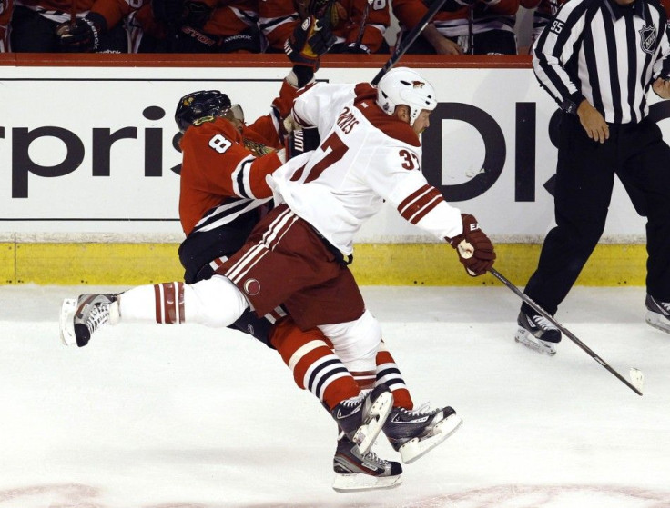 Phoenix&#039;s Raffi Torres crunches Chicago&#039;s Marian Hossa Tuesday night.