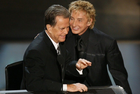 Dick Clark and singer Barry Manilow stand on stage during a tribute to Clark in which Manilow performed at the 58th annual Primetime Emmy Awards at the Shrine Auditorium in Los Angeles
