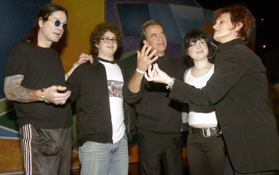 Sharon Osbournes jokes around with Dick Clark as L to R husband Ozzy Osbourne, son Jack and daughter Kelly look on before rehearsing on January 11, 2003 for the upcoming American Music Awards in Los Angeles. 