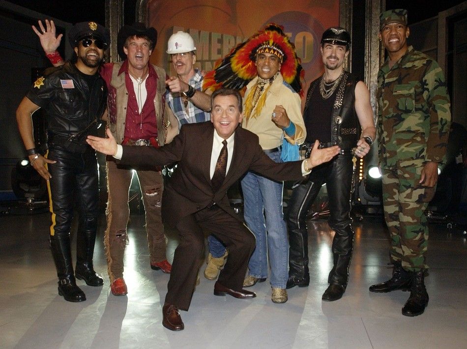 Host Dick Clark C, poses for photographers with members of the Village People before the Disco group performed a medley of their hit songs during a taping of quotAmerican Bandstands 50th...A Celebrationquot in Pasadena, California, April 20, 2002. 