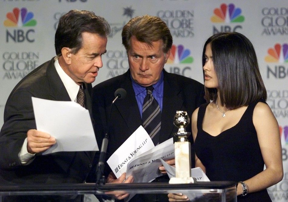 Actor Martin Sheen C reacts as producer Dick Clark L corrects a mistake Sheen made during the announcement ceremonies for the 57th Annual Golden Globe Awards December 20 in Beverly Hills, California. Actress Salma Hayek shares the podium with the men.