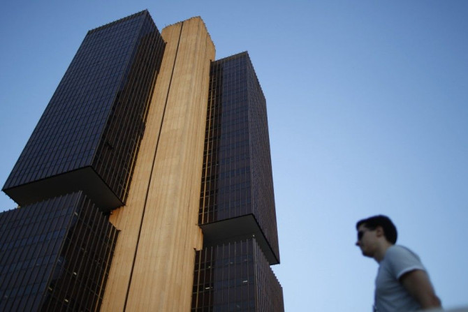 A man stands near the headquarters of the central bank in Brasilia September 22, 2011.
