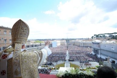Pope Benedict XVI waves as he makes his &quot;Urbi et Orbi&quot; (To the city and the world) address from a balcony in St. Peter&#039;s Square in Vatican