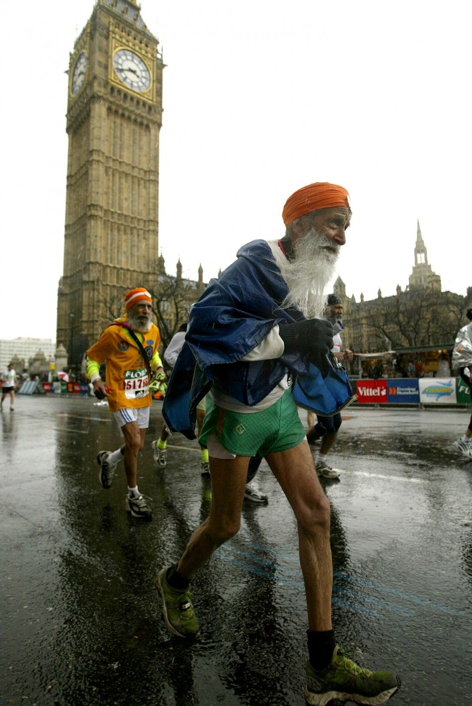 The oldest runner competing in the London marathon, 93-year-old Fauja Singh, passes the Houses of Parliament, April 18, 2004.