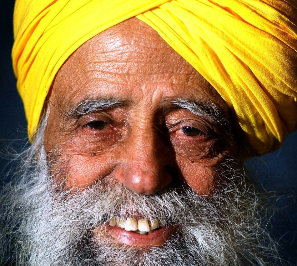 The oldest runner due to take part in the 2004 London Marathon, 93-year-old Fauja Singh, poses for photographs in east London, April 16, 2004.