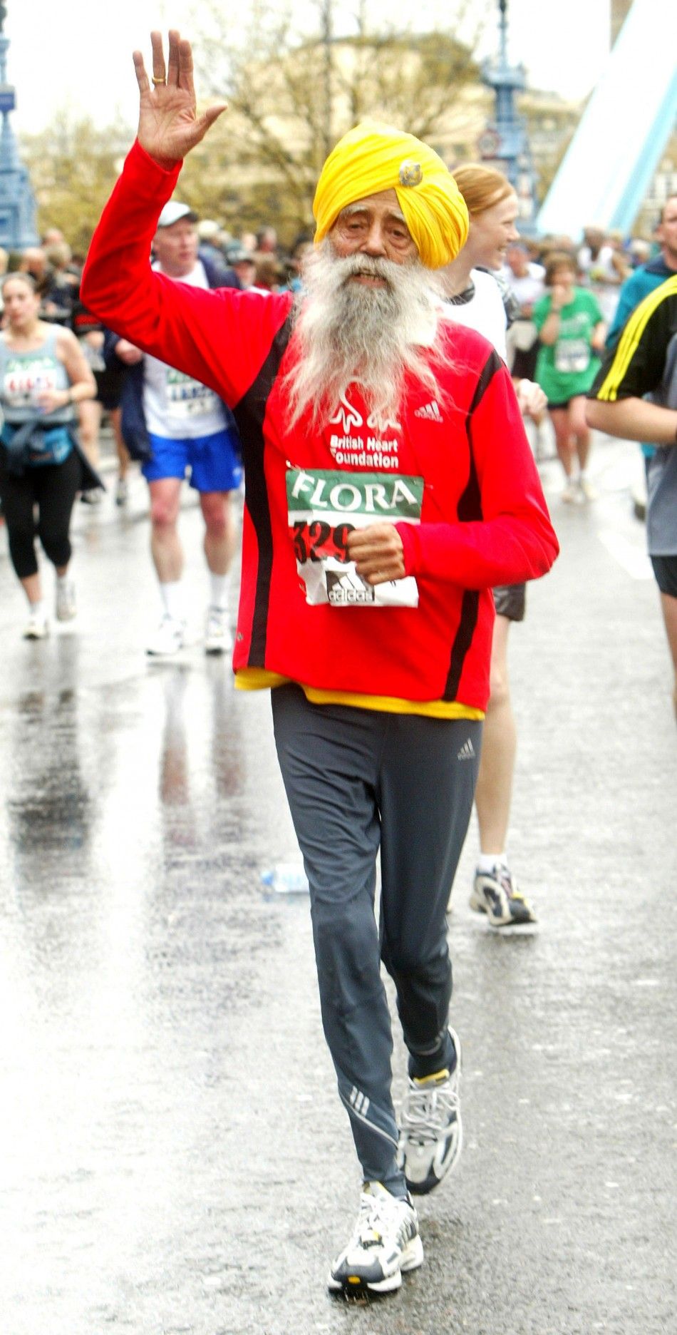 The oldest runner taking part in the London marathon, 93-year-old Fauja Singh, crosses Tower Bridge, April 18, 2004.
