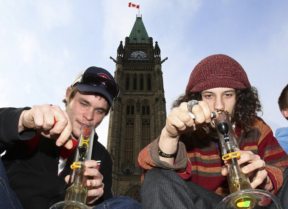 Men smoke marijuana during a 420 rally to demand the legalization of marijuana on Parliament Hill in Ottawa