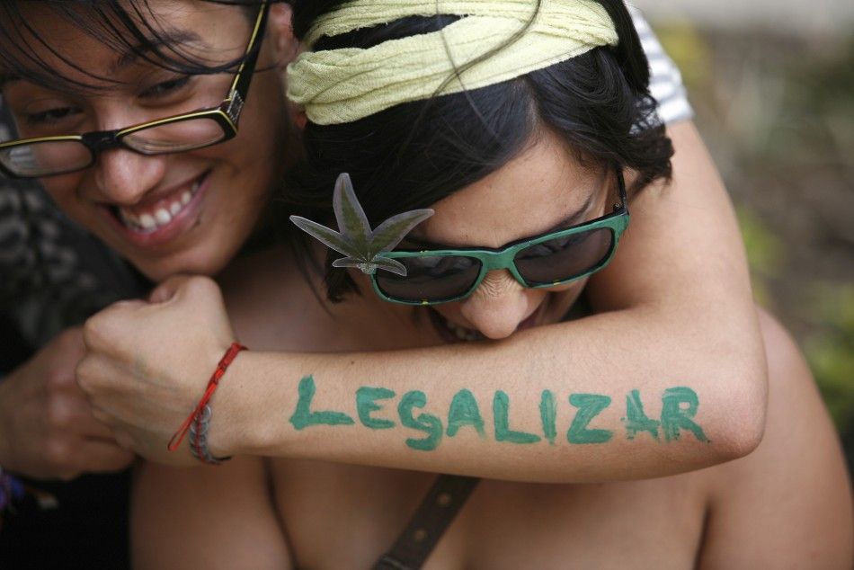 A woman embraces her friend during a rally to demand the legalization of marijuana in Mexico City
