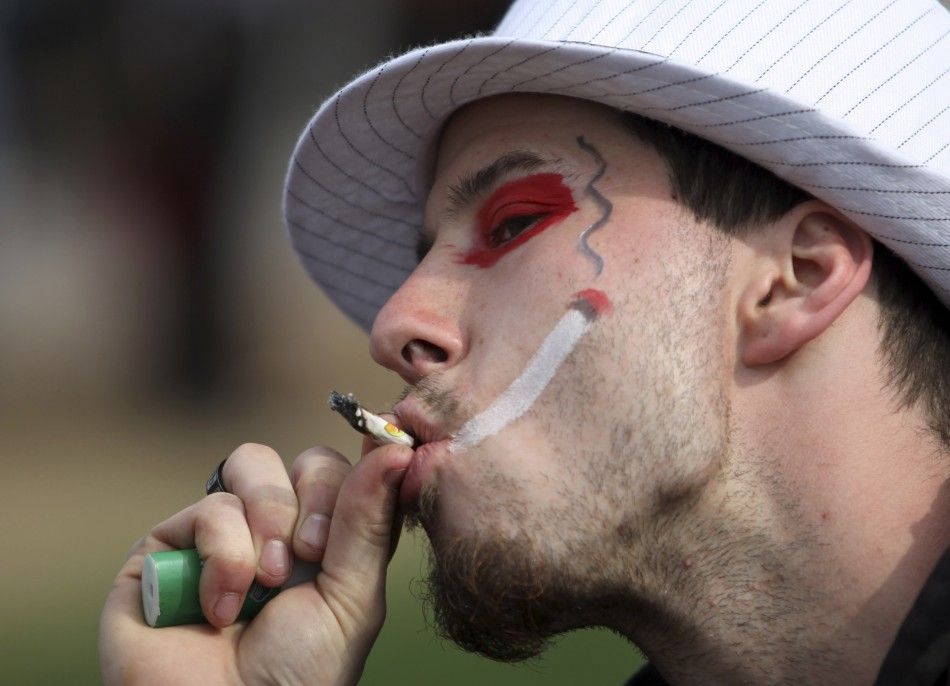 A man smokes marijuana during a 420 rally to demand the legalization of marijuana on Parliament Hill in Ottawa