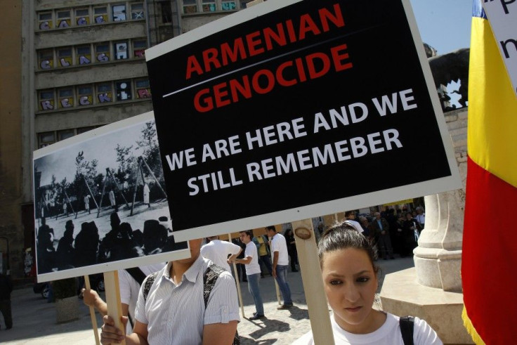 Members of Armenian community in Romania hold banners during a rally marking the anniversary of mass killings of Armenians in Ottoman Empire in 1915, in downtown Bucharest