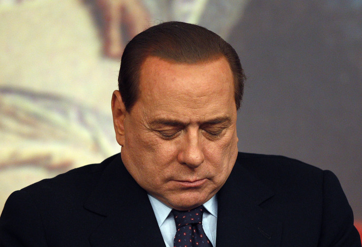 Berlusconi sleeping with head in hands