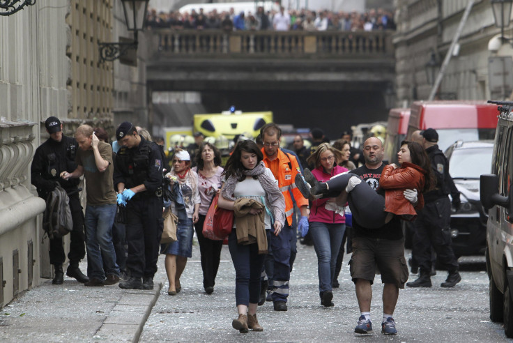 Injured people leave an area in Prague after explosion
