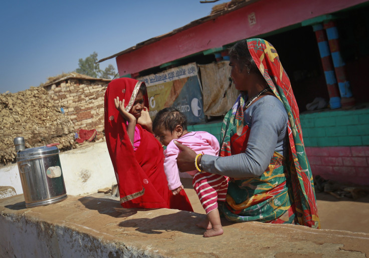 India mother holding baby near Baran Jan 2013