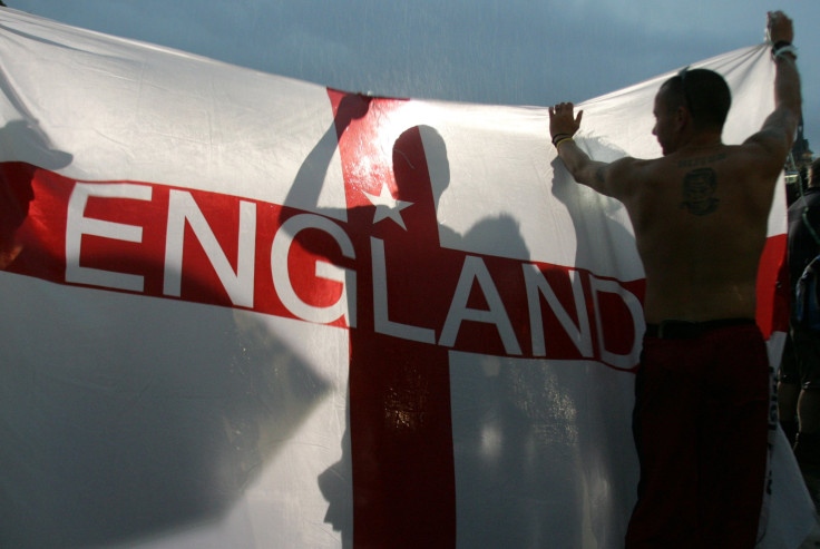 A England soccer fan celebrates with a St. George cross flag