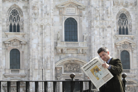 A man reads an Italian newspaper in Duomo square in downtown Milan.