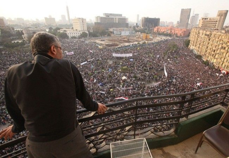 A man looks on as protesters take part in an anti-Mubarak protest at Tahrir Square in Cairo February 1, 2011. At least one million Egyptians took to the streets on Tuesday in scenes never before seen in the Arab nation's modern history, roaring in unison 