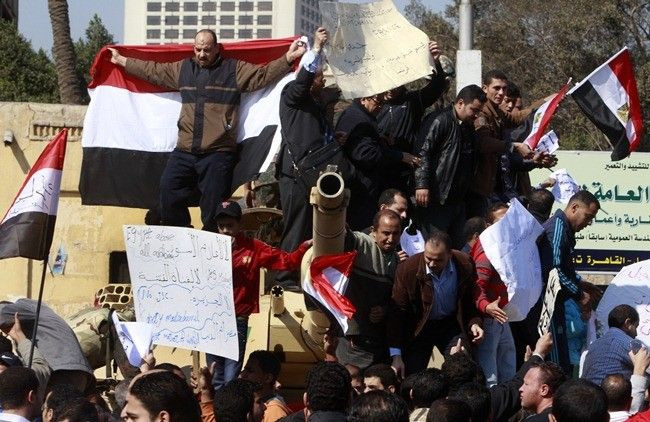 Pro-government supporters of Egyptian President Hosni Mubarak shout slogans atop an army tank near Tahrir square in central Cairo February 2, 2011.