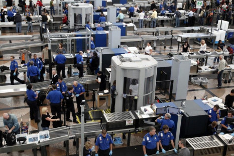 TSA workers carry out security checks at Denver International Airport, the day before the Thanksgiving holiday in Denver.