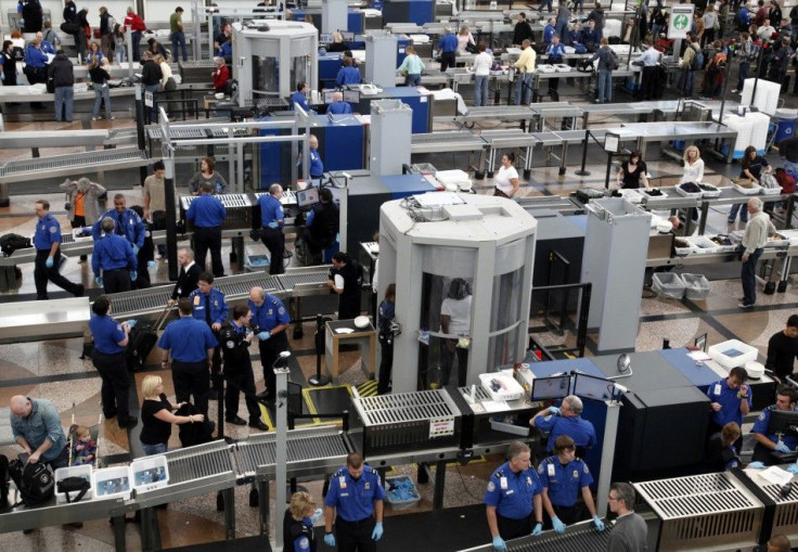 TSA workers carry out security checks at Denver International Airport, the day before the Thanksgiving holiday in Denver.