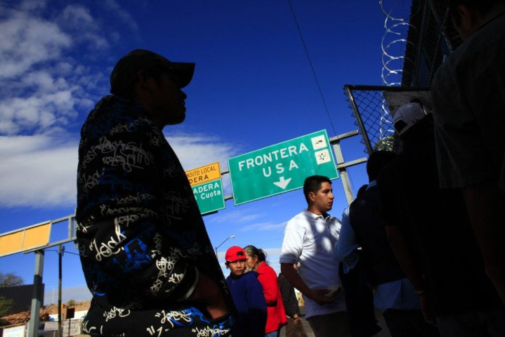 People wait outside an aid center near a truck port of entry in Nogales, Mexico