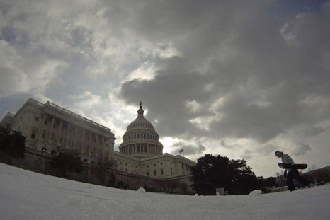 Lindsay Cronin carries her snowboard back up the hill in front of the U.S. Capitol Building in Washington January 27, 2011. 