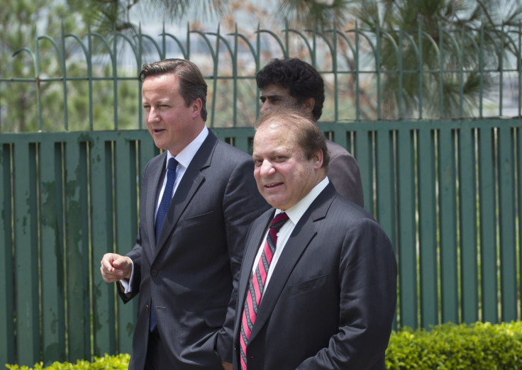 Pakistan's Prime Minister Nawaz Sharif (R) smiles and talks with his British counterpart David Cameron (L) as they leaves a joint news conference in Islamabad June 30, 2013