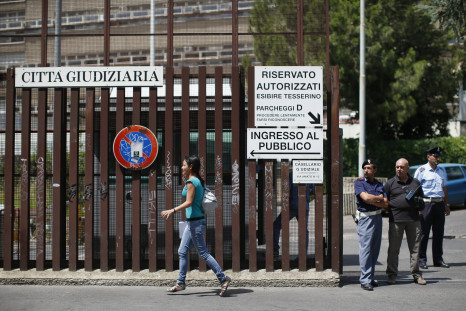 A woman walks past the entrance of the courthouse in Rome June 28, 2013.
