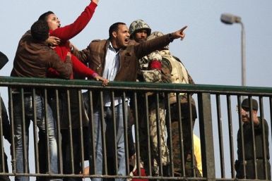 Pro-Mubarak supporters shout at opposition demonstrators as soldiers try to calm them down on a bridge near Tahrir Square in Cairo February 3, 2011. 