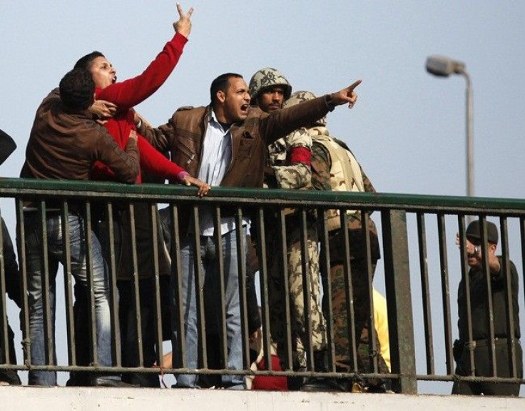 Pro-Mubarak supporters shout at opposition demonstrators as soldiers try to calm them down on a bridge near Tahrir Square in Cairo February 3, 2011. 