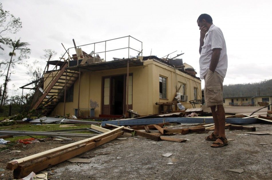 A man stands near his friends ruined house after Cyclone Yasi passed the northern Australian town of Tully