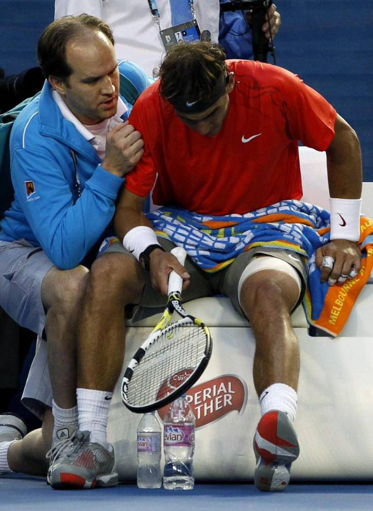A medical official attends to Nadal of Spain during his quarter-final match against compatriot Ferrer at the Australian Open tennis tournament in Melbourne.