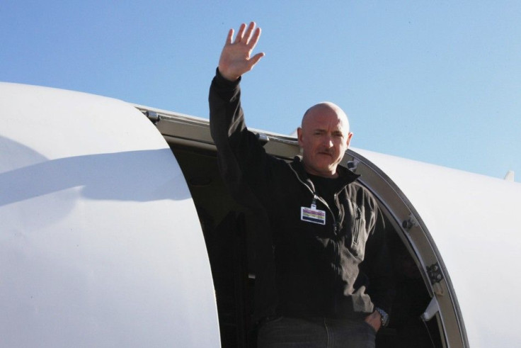 Handout shows NASA Shuttle Commander Kelly waving from a medical transport plane bound for Houston, after his wife was carried aboard in Tucson, Arizona