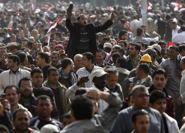 An opposition supporter waves his shoe, a sign of disrespect, shortly after Friday prayers in Tahrir Square in Cairo February 4, 2011. 