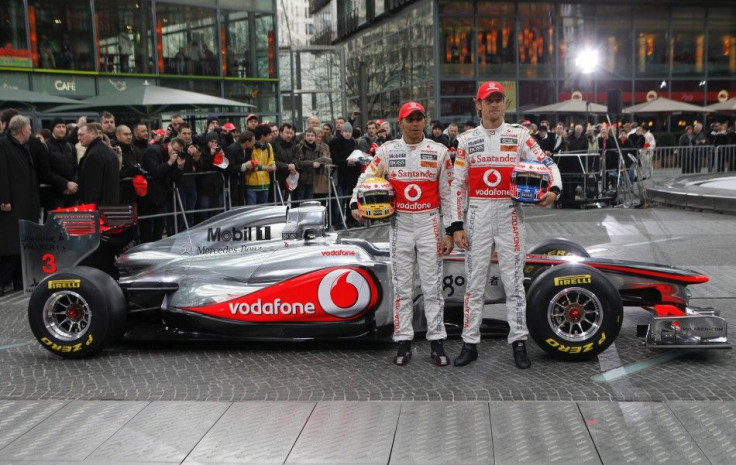 McLaren Formula One racing drivers Hamilton and Button of Britain pose for pictures during revealing of McLaren Mercedes MP4-26 racing car in Berlin.