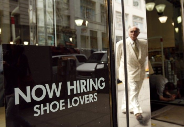 A sign in the window of a retail shoe store advertises for jobs in San Francisco, California