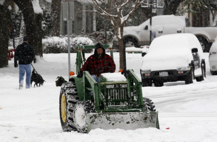 A staff member removes snow in Dallas 