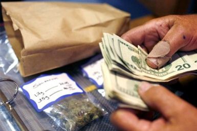 A customer makes a medical marijuana purchase at the Coffeeshop Blue Sky dispensary in Oakland, California June 30, 2010