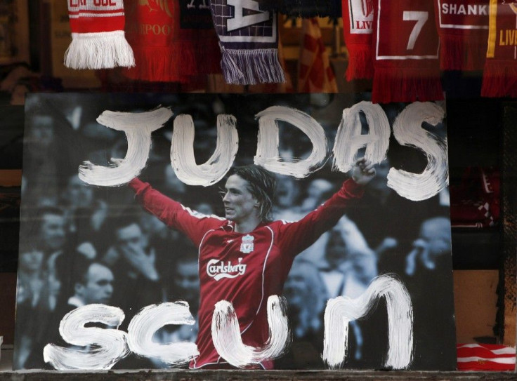 Defaced Fernando Torres photograph is displayed in the window of a souvenir shop in Liverpool.