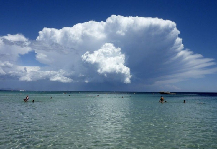 A cumulonimbus cloud is growing over the sea in front of Saint-Tropez on the French Riviera