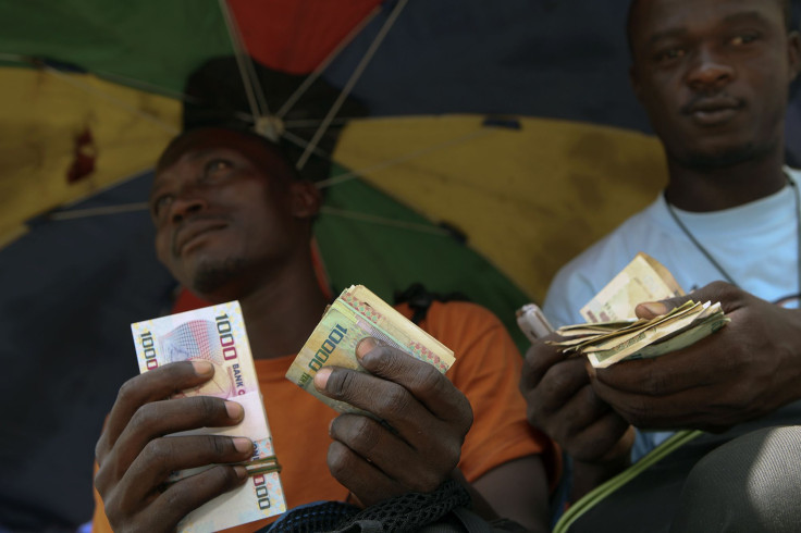 Men counting Leones in Sierra Leone