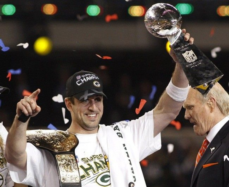 Green Bay Packers MVP quarterback Aaron Rodgers celebrates with the Vince Lombardi trophy after the Packers defeated the Pittsburgh Steelers in the NFL's Super Bowl XLV football game in Arlington, Texas, February 6, 2011. Rodgers was voted MVP of the game