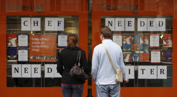 Pedestrians read recruitment announcements in central London