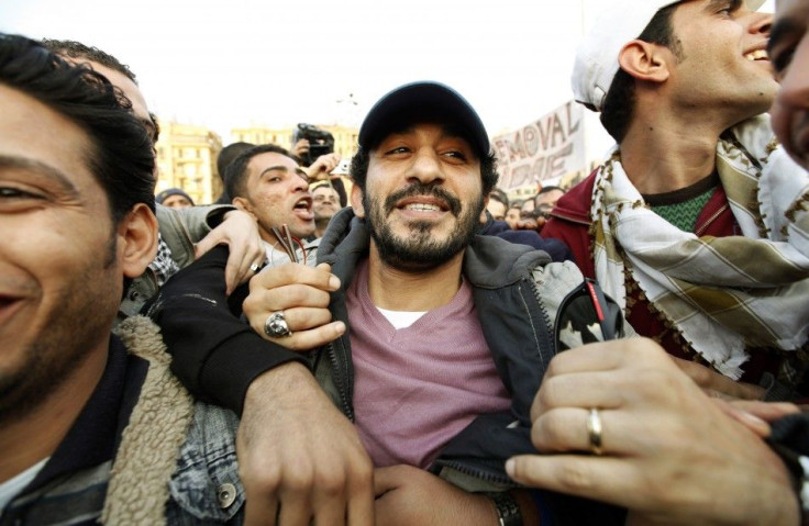Anti-government protesters embrace Egyptian actor Ahmed Helmy as he visits demonstrations inside Tahrir Square in Cairo