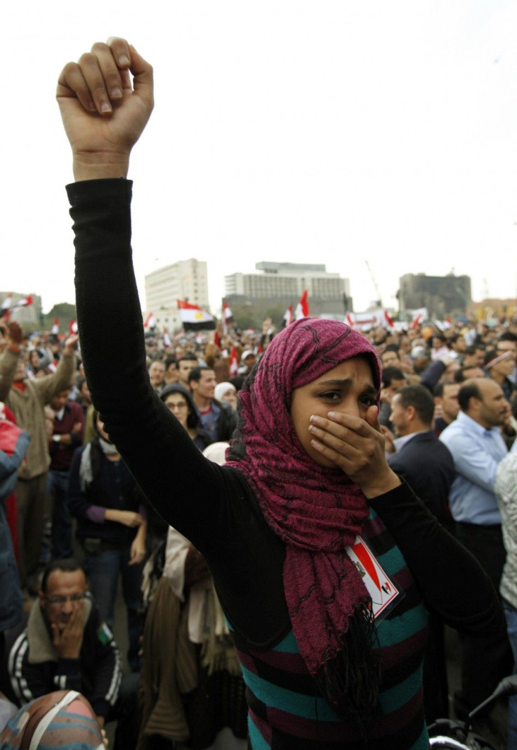 A protester holds back her tears as she chants anti-government slogans during demonstrations at Tahrir Square in Cairo