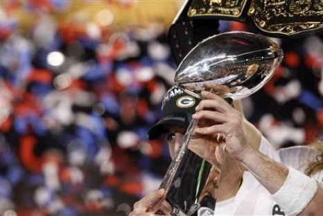 Green Bay Packers' quarterback Aaron Rodgers holds the Vince Lombardi Trophy after his team defeated the Pittsburgh Steelers, 31-25, in the NFL's Super Bowl XLV football game in Arlington, Texas, February 6, 2011. 