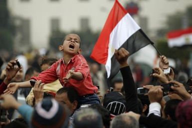 A young protester chants anti-government slogans during demonstrations inside Tahrir Square in Cairo